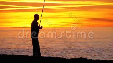 渔人剪影：海上日落时的钓鱼竿